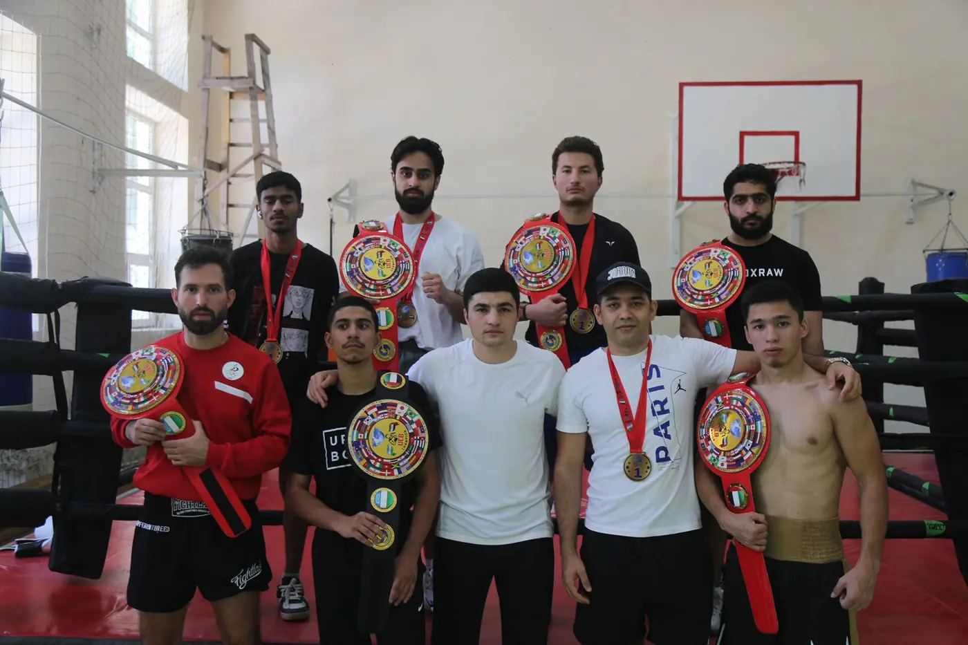 Champions with belts in the ring